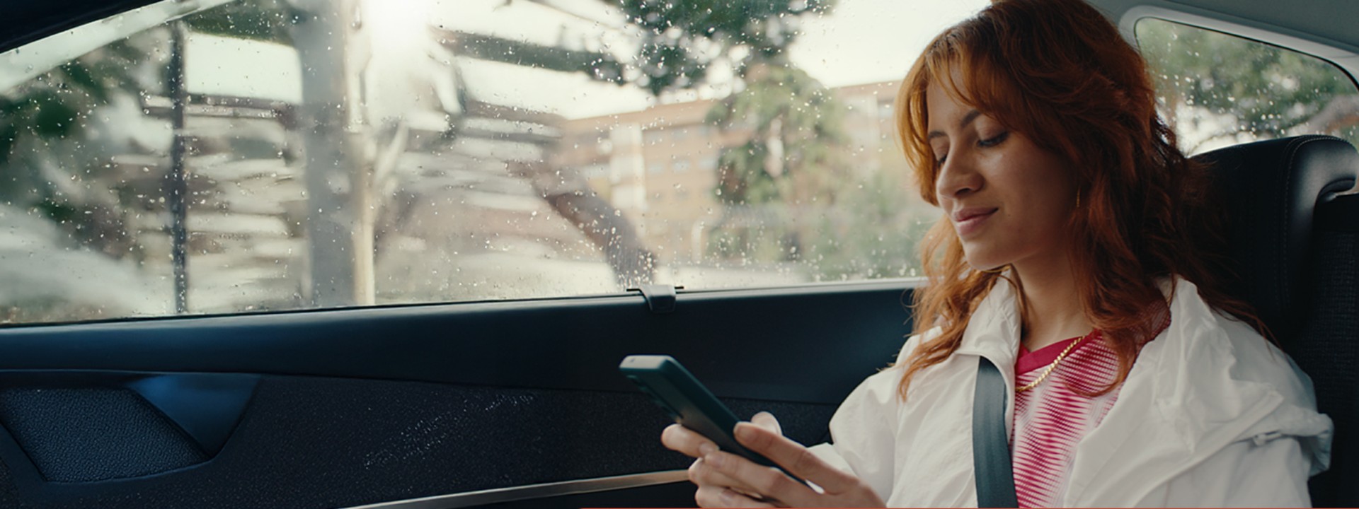 woman in car using mobile