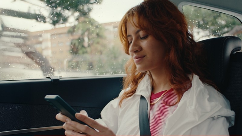 woman in car using mobile