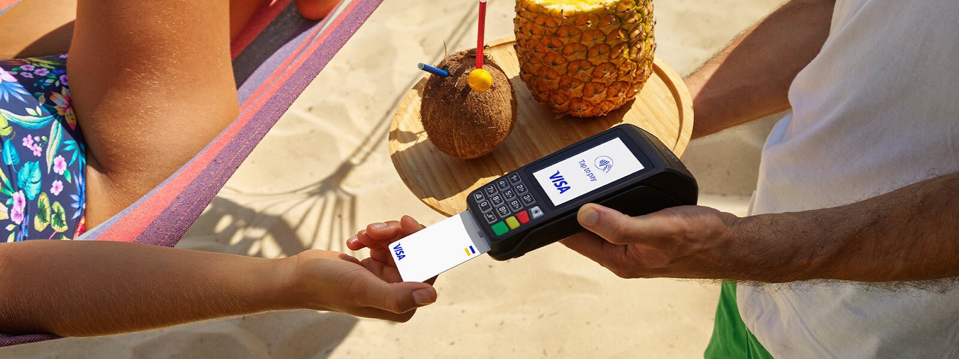 person on a hammock paying with their visa card