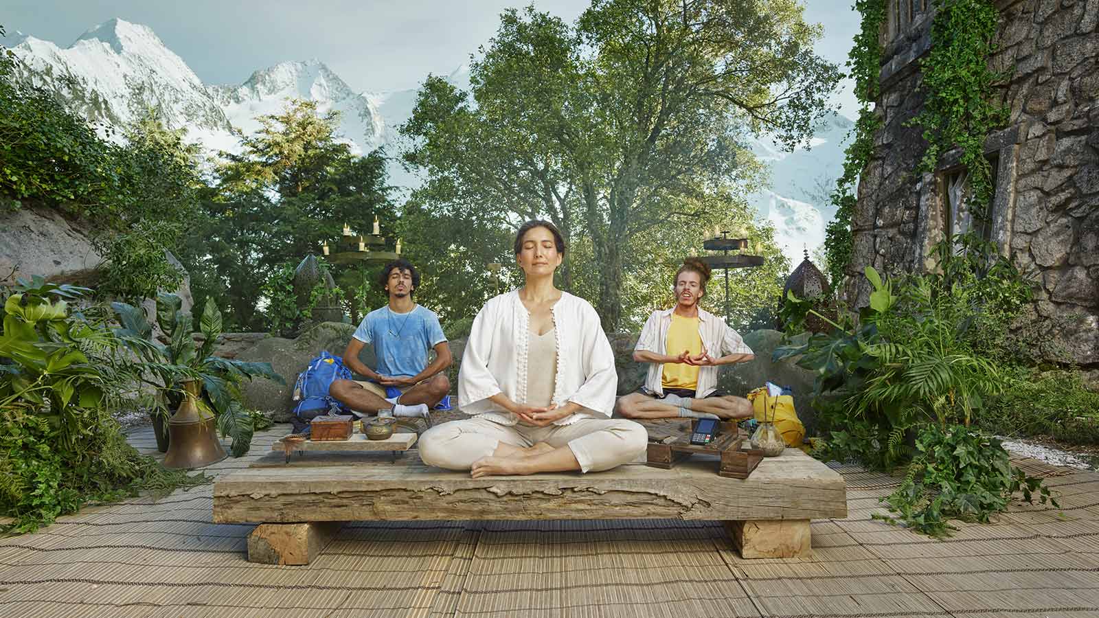 three people in a yoga pose on a holiday retreat in the jungle