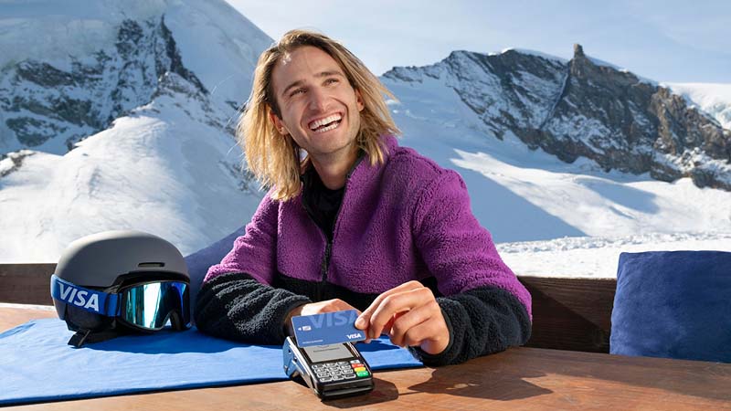 Team Visa athlete Pat Burgener paying with a Visa card in the Swiss alps.